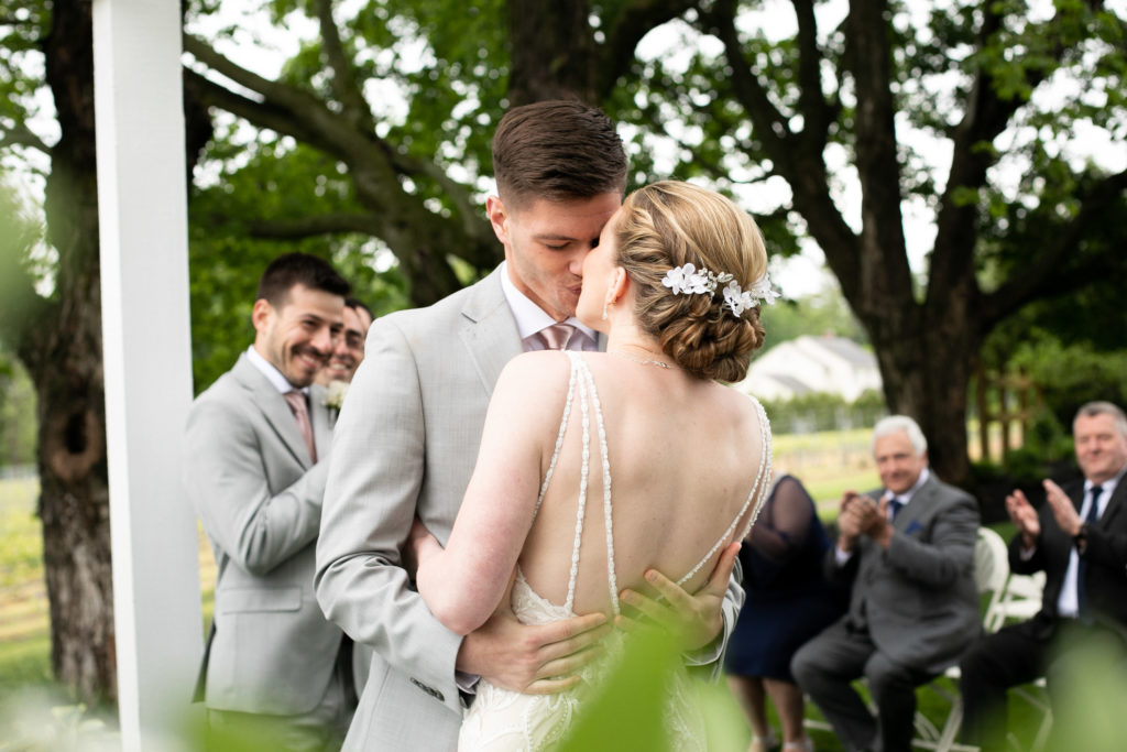 Bride and Groom share their first kiss with their close friends and family at the ceremony