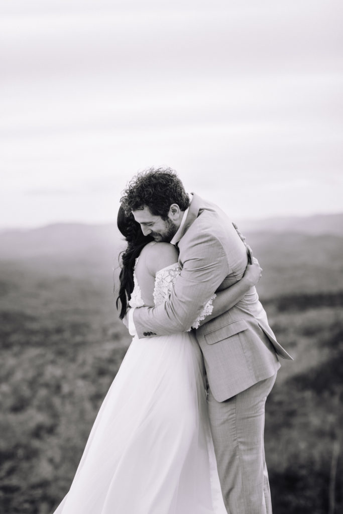 Husband and Wife embrace in the mountains in New England 