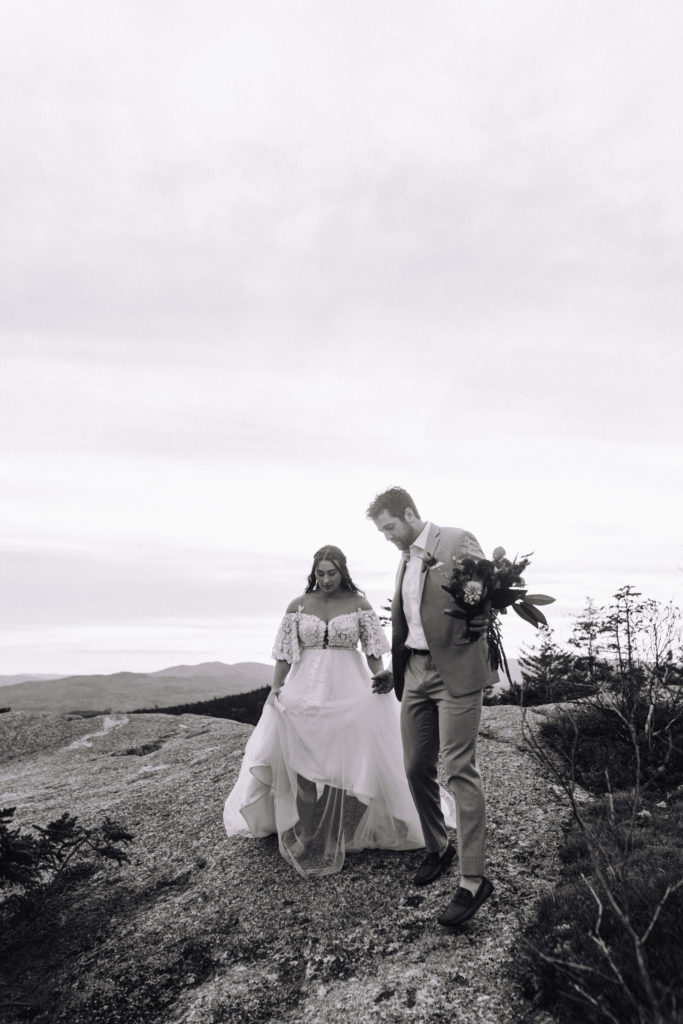 Man leads wife through the White Mountains on their New England Elopement day
