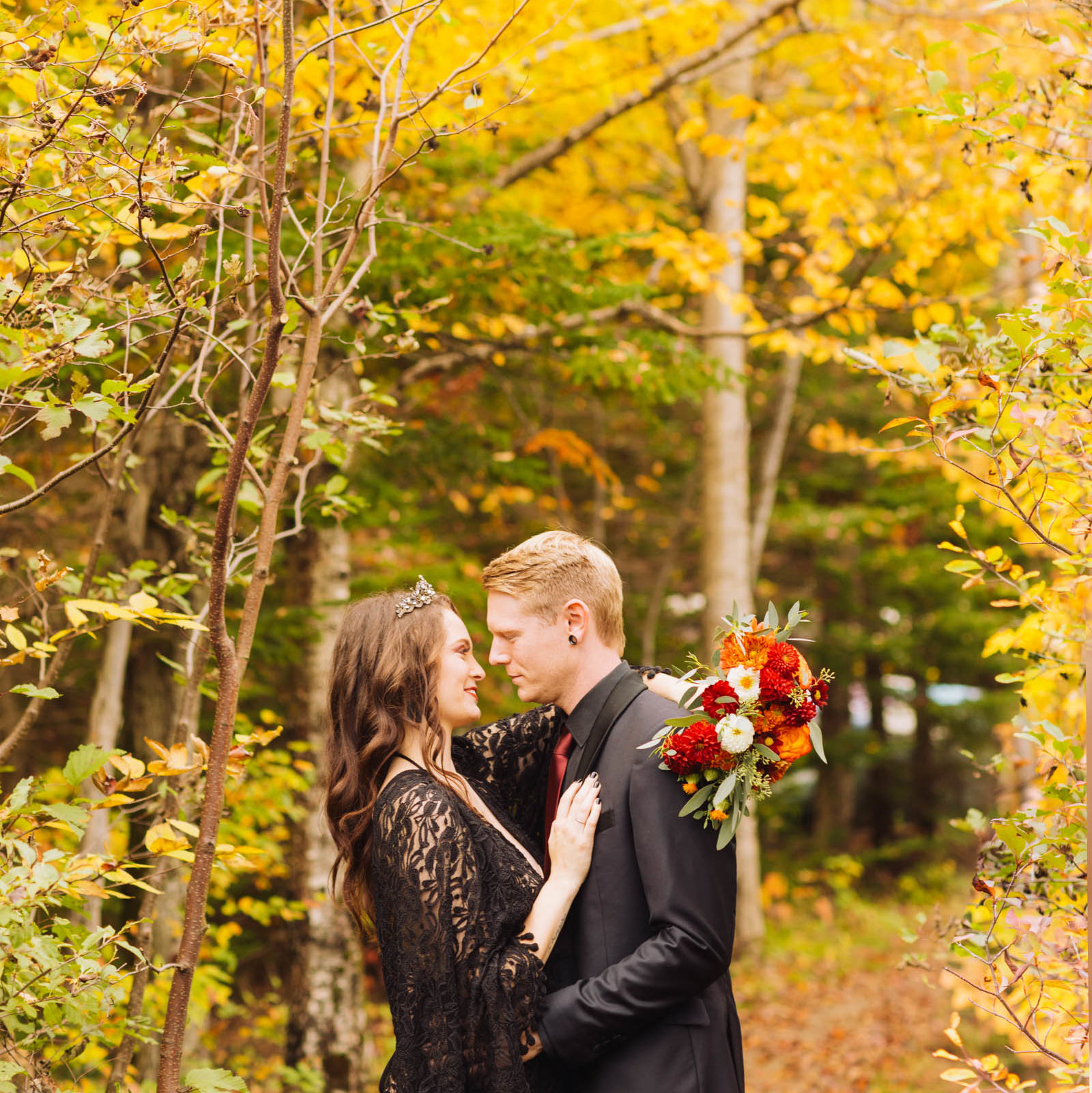 Husband and Wife Embrace under Fall Foliage